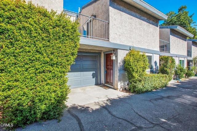 808 Magnolia Ave Unit 3, Pasadena, CA 91106 - view of front of home with a balcony, an attached garage, driveway, and stucco siding