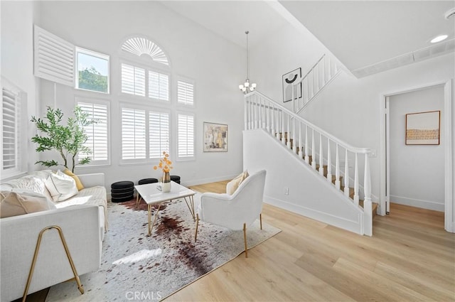 575 E Nubia St, Covina, CA 91722 - living area with stairs, wood finished floors, plenty of natural light, a high ceiling, and a chandelier