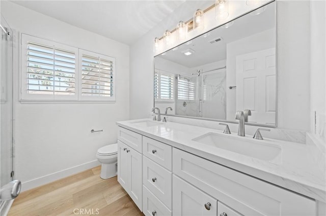 575 E Nubia St, Covina, CA 91722 - bathroom featuring double vanity, a stall shower, and wood finished floors