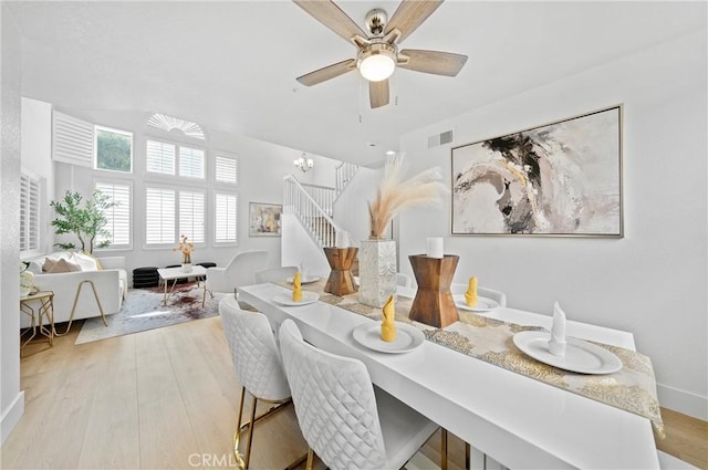 575 E Nubia St, Covina, CA 91722 - dining space with wood finished floors, stairs, ceiling fan, and a chandelier