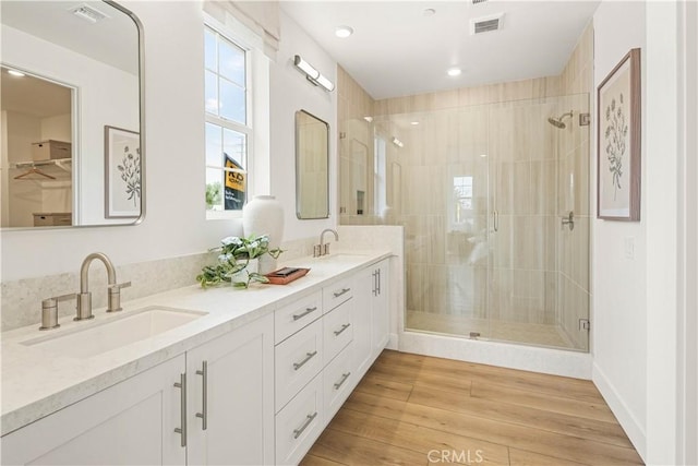 4836 Arroyo Run, Moorpark, CA 93021 - bathroom with a shower stall, double vanity, wood finished floors, and recessed lighting