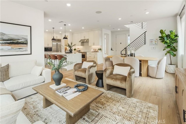 4836 Arroyo Run, Moorpark, CA 93021 - living room with light wood finished floors, stairway, and recessed lighting