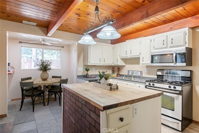 2616 Secret Dr, Running Springs, CA 92382 - kitchen featuring stainless steel appliances, a wood ceiling with exposed beams, butcher block countertops, white cabinetry, and pendant lighting