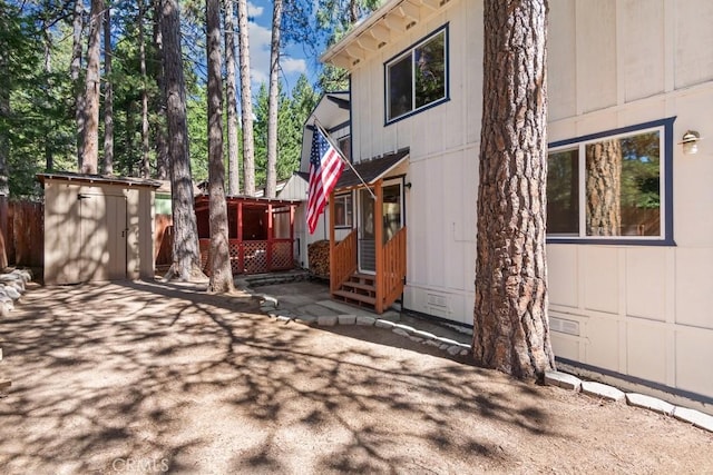 2616 Secret Dr, Running Springs, CA 92382 - view of property exterior featuring a storage unit, entry steps, and a patio area