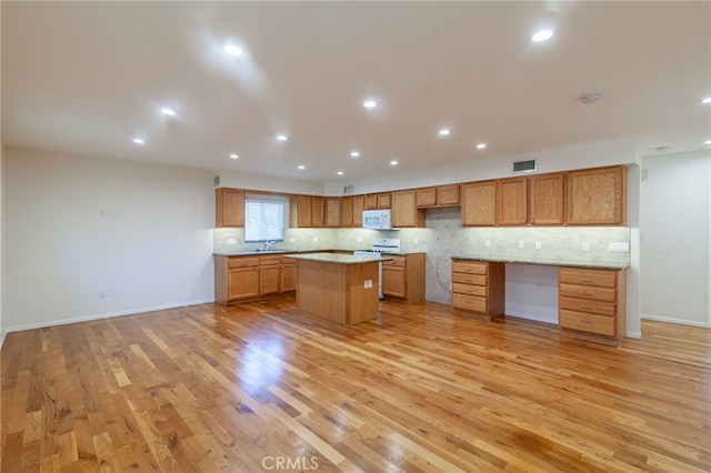 10838 Burnet Ave, San Fernando, CA 91345 - kitchen featuring white appliances, light wood finished floors, a center island, decorative backsplash, and recessed lighting