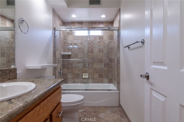 10838 Burnet Ave, San Fernando, CA 91345 - bathroom featuring vanity, bath / shower combo with glass door, and stone finish flooring