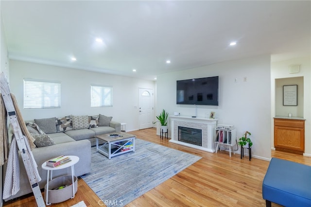 10838 Burnet Ave, San Fernando, CA 91345 - living area with light wood finished floors, recessed lighting, and a glass covered fireplace