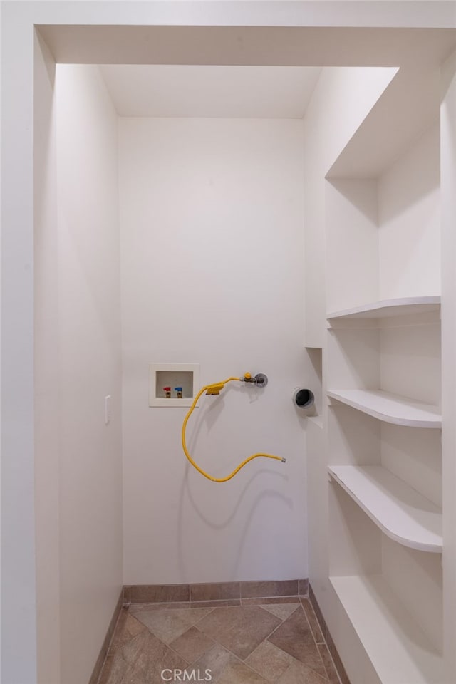 10838 Burnet Ave, San Fernando, CA 91345 - washroom featuring washer hookup and stone finish flooring