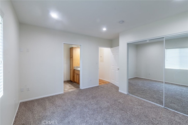 10838 Burnet Ave, San Fernando, CA 91345 - unfurnished bedroom featuring a closet, light colored carpet, ensuite bath, and recessed lighting