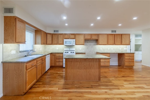 10838 Burnet Ave, San Fernando, CA 91345 - kitchen with white appliances, a center island, light wood-style flooring, backsplash, and recessed lighting