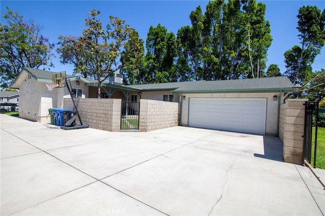 10838 Burnet Ave, San Fernando, CA 91345 - view of front of property with concrete driveway, stucco siding, an attached garage, and a gate