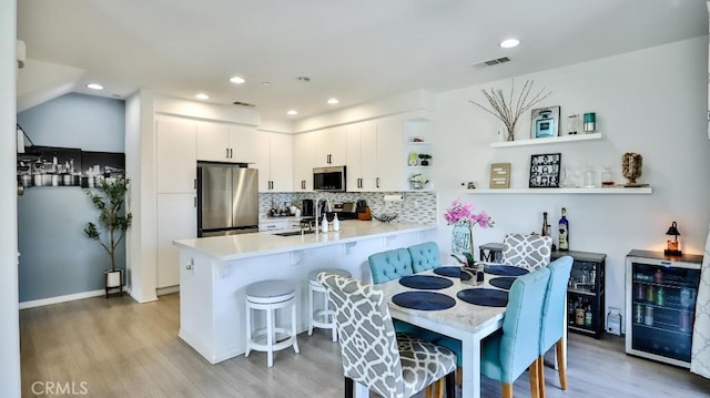 17554 Waterfall Ct, Fountain Valley, CA 92708 - dining space featuring beverage cooler, light wood finished floors, and recessed lighting
