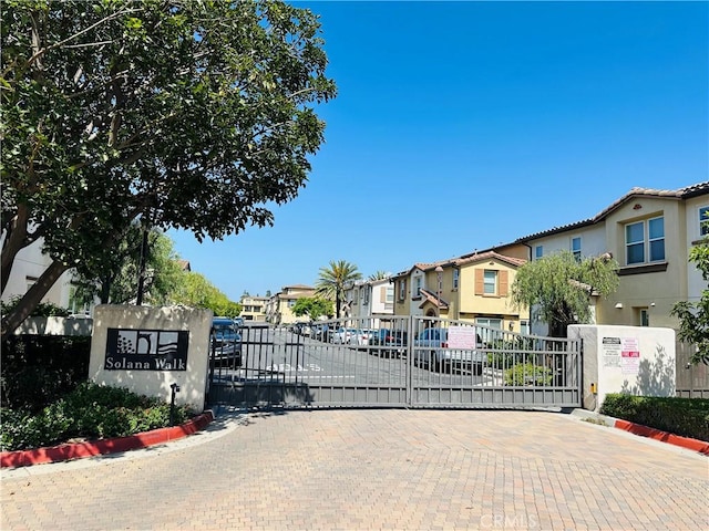 17554 Waterfall Ct, Fountain Valley, CA 92708 - view of decorative road featuring curbs, a residential view, a gate, and a gated entry