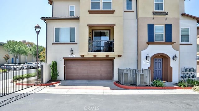 17554 Waterfall Ct, Fountain Valley, CA 92708 - view of property featuring stucco siding, an attached garage, and driveway