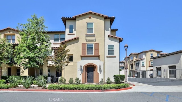 17554 Waterfall Ct, Fountain Valley, CA 92708 - view of front facade with stucco siding, a tiled roof, and a gate
