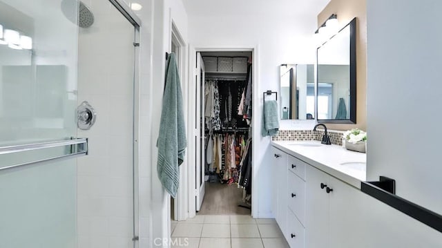 17554 Waterfall Ct, Fountain Valley, CA 92708 - bathroom featuring a stall shower, a spacious closet, double vanity, and backsplash