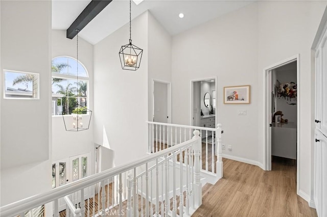 2017 Curtis Ave Unit B, Redondo Beach, CA 90278 - hallway with an upstairs landing, high vaulted ceiling, a chandelier, light wood finished floors, and beamed ceiling