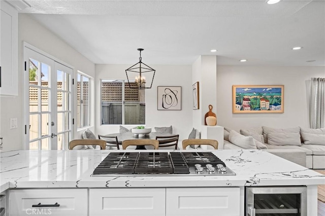 2017 Curtis Ave Unit B, Redondo Beach, CA 90278 - kitchen with beverage cooler, a chandelier, white cabinets, light stone counters, and hanging light fixtures