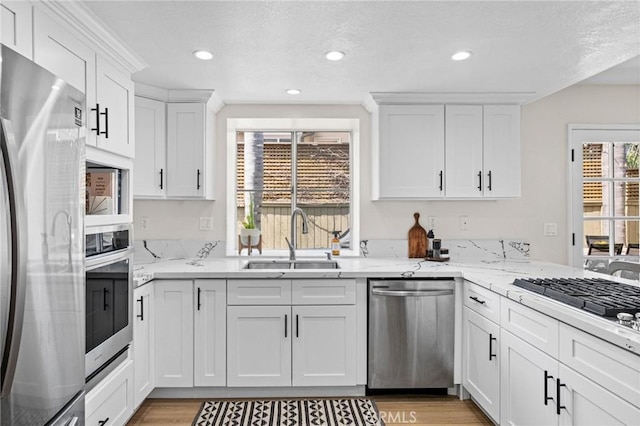 2017 Curtis Ave Unit B, Redondo Beach, CA 90278 - kitchen featuring stainless steel appliances, white cabinets, light wood-style floors, light stone countertops, and recessed lighting