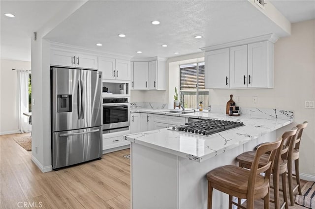 2017 Curtis Ave Unit B, Redondo Beach, CA 90278 - kitchen with stainless steel appliances, plenty of natural light, a peninsula, recessed lighting, and light stone counters