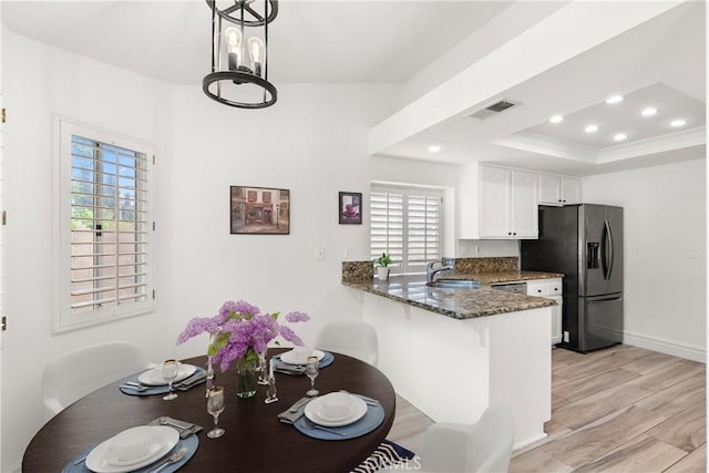 5650 Harvest Way, Yorba Linda, CA 92886 - kitchen featuring stainless steel refrigerator with ice dispenser, dark stone countertops, white cabinets, a peninsula, and a breakfast bar