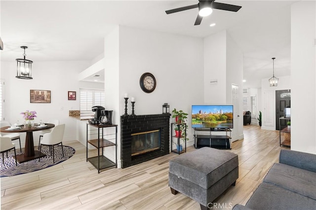 5650 Harvest Way, Yorba Linda, CA 92886 - living area featuring a ceiling fan, wood finished floors, a brick fireplace, recessed lighting, and a chandelier