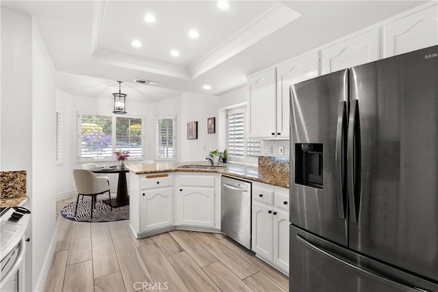 5650 Harvest Way, Yorba Linda, CA 92886 - kitchen with appliances with stainless steel finishes, a tray ceiling, a peninsula, recessed lighting, and white cabinetry