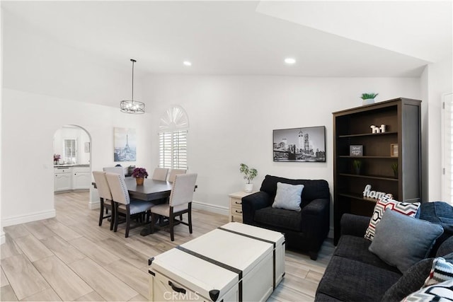 5650 Harvest Way, Yorba Linda, CA 92886 - living room featuring lofted ceiling, arched walkways, recessed lighting, light wood-style flooring, and a chandelier