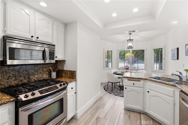 5650 Harvest Way, Yorba Linda, CA 92886 - kitchen with appliances with stainless steel finishes, a raised ceiling, white cabinets, recessed lighting, and decorative backsplash