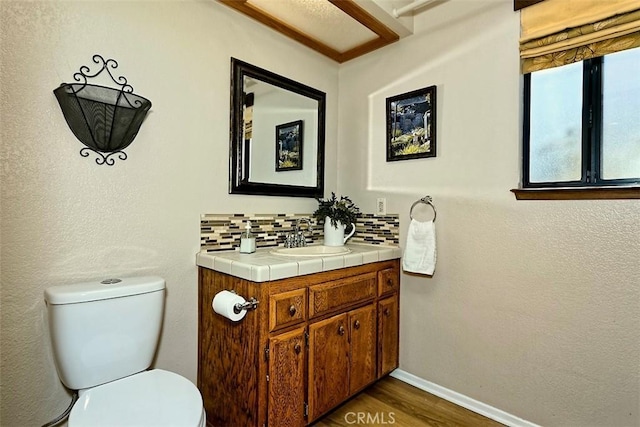 15381 Otomian Rd, Apple Valley, CA 92307 - bathroom with vanity, decorative backsplash, and wood finished floors