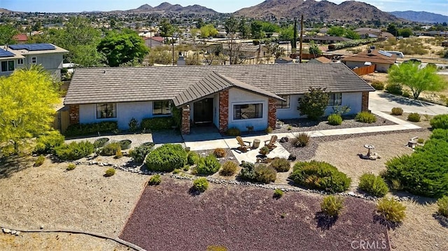 15381 Otomian Rd, Apple Valley, CA 92307 - view of front facade featuring stucco siding, a mountain view, and a tile roof
