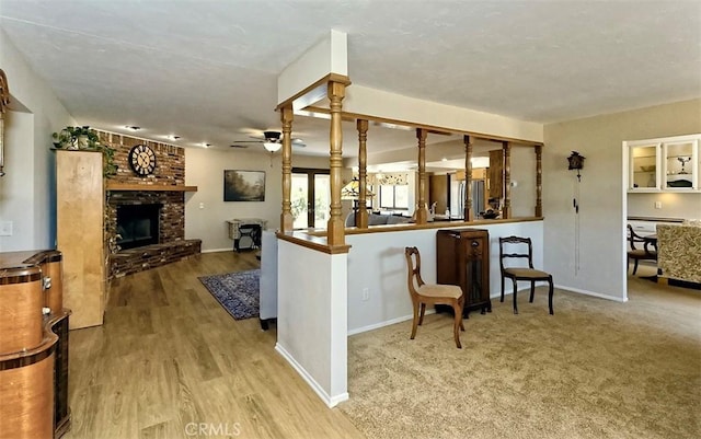15381 Otomian Rd, Apple Valley, CA 92307 - kitchen with ceiling fan, a brick fireplace, wood finished floors, and freestanding refrigerator