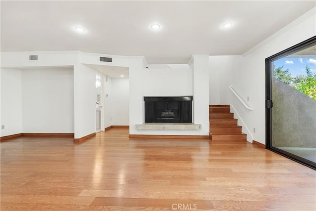 7137 Shoup Ave Unit 39, West Hills, CA 91307 - unfurnished living room featuring light wood finished floors, a fireplace with raised hearth, stairway, recessed lighting, and ornamental molding