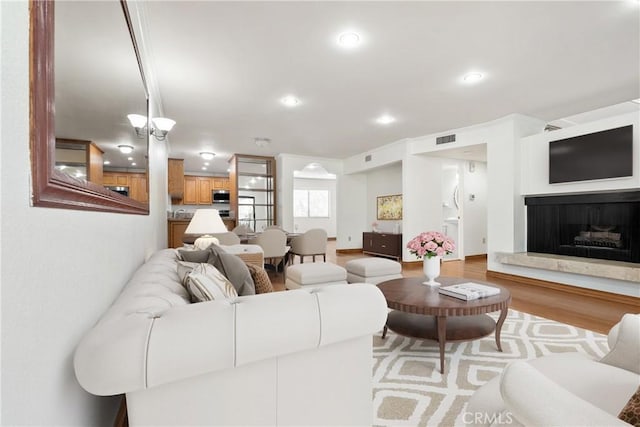 7137 Shoup Ave Unit 39, West Hills, CA 91307 - living area with wood finished floors, a fireplace with raised hearth, and recessed lighting