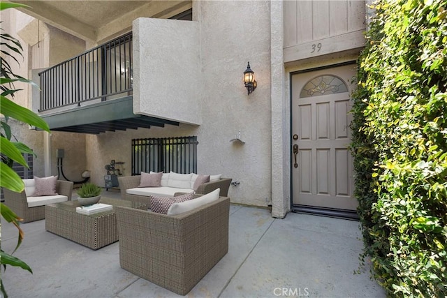 7137 Shoup Ave Unit 39, West Hills, CA 91307 - entrance to property with a balcony, stucco siding, an outdoor hangout area, and a patio