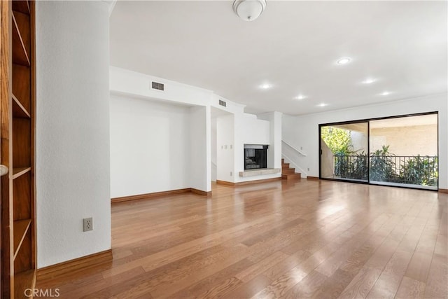 7137 Shoup Ave Unit 39, West Hills, CA 91307 - unfurnished living room featuring wood finished floors, stairs, and recessed lighting