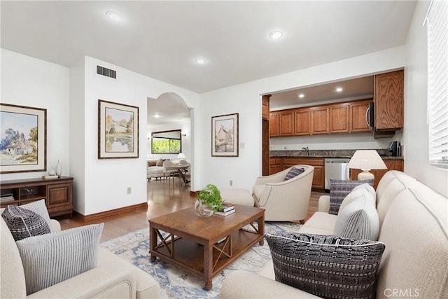 7137 Shoup Ave Unit 39, West Hills, CA 91307 - living room with arched walkways, light wood finished floors, and recessed lighting