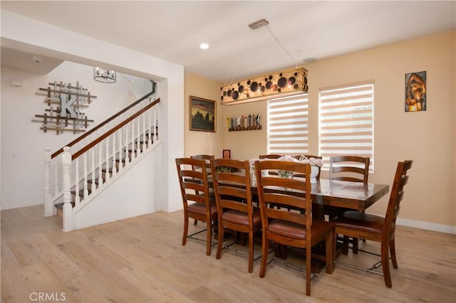19680 Griffith Dr, Saugus, CA 91350 - dining area with wood finished floors, stairs, and recessed lighting
