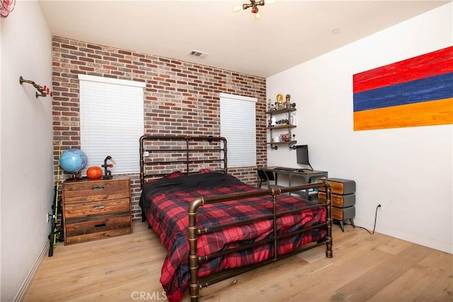 19680 Griffith Dr, Saugus, CA 91350 - bedroom with wood finished floors and brick wall