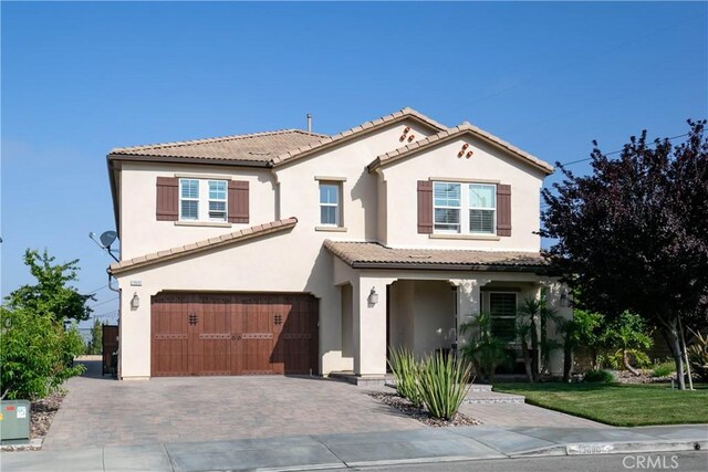 19680 Griffith Dr, Saugus, CA 91350 - view of front of house with a tiled roof, a garage, stucco siding, and decorative driveway