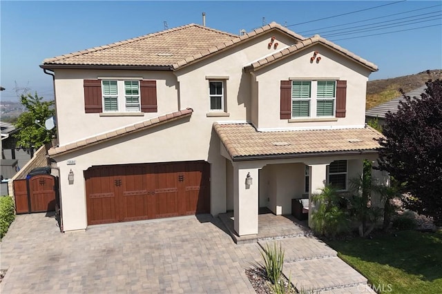 19680 Griffith Dr, Saugus, CA 91350 - view of front of home with an attached garage, stucco siding, and a tile roof