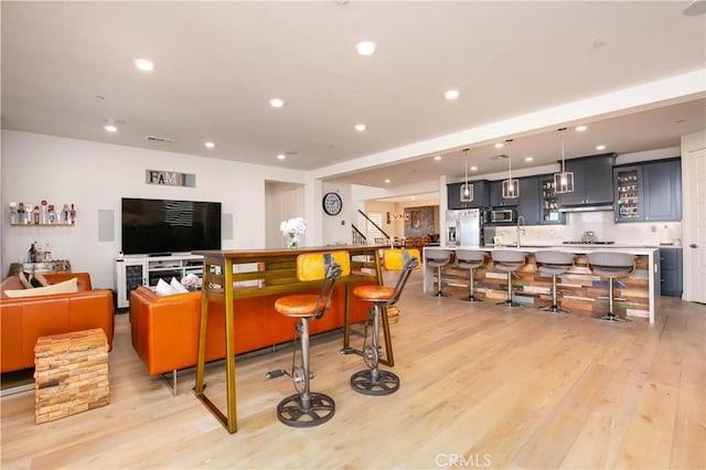 19680 Griffith Dr, Saugus, CA 91350 - living area with light wood-style flooring, recessed lighting, and stairway