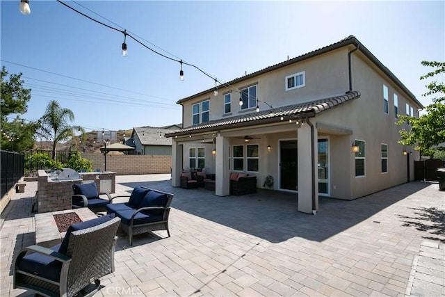 19680 Griffith Dr, Saugus, CA 91350 - back of house with an outdoor hangout area, exterior kitchen, a fenced backyard, and stucco siding