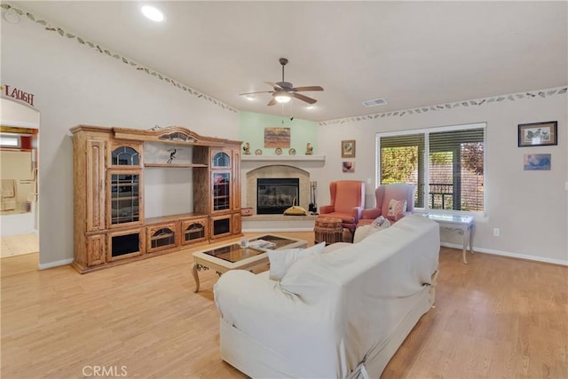 14908 Dakota Rd, Apple Valley, CA 92307 - living area featuring ceiling fan, light wood-style floors, and a glass covered fireplace