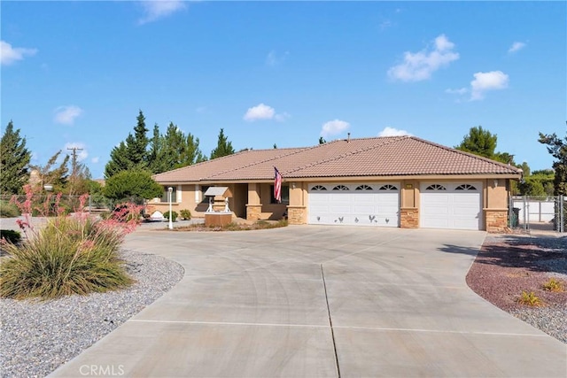 14908 Dakota Rd, Apple Valley, CA 92307 - single story home with stucco siding, concrete driveway, an attached garage, stone siding, and a tiled roof