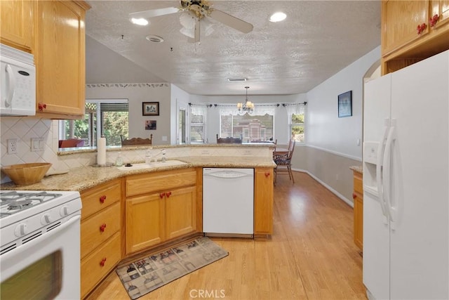 14908 Dakota Rd, Apple Valley, CA 92307 - kitchen featuring white appliances, a peninsula, light wood-style flooring, a textured ceiling, and a ceiling fan