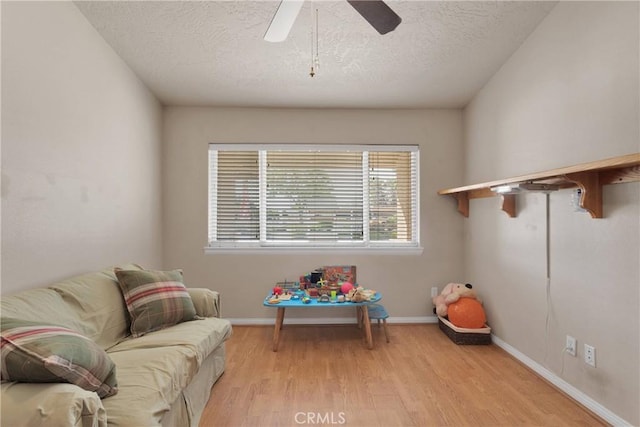 14908 Dakota Rd, Apple Valley, CA 92307 - recreation room with light wood-style floors, a textured ceiling, and ceiling fan