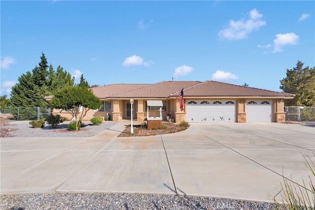 14908 Dakota Rd, Apple Valley, CA 92307 - ranch-style house featuring concrete driveway, stone siding, a tile roof, and stucco siding