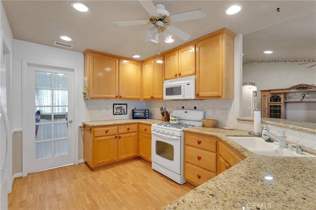 14908 Dakota Rd, Apple Valley, CA 92307 - kitchen with white appliances, light wood-style floors, backsplash, light stone counters, and recessed lighting