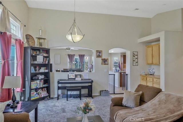 32124 Evening Primrose Trl, Campo, CA 91906 - living room with arched walkways, a ceiling fan, carpet floors, and a towering ceiling